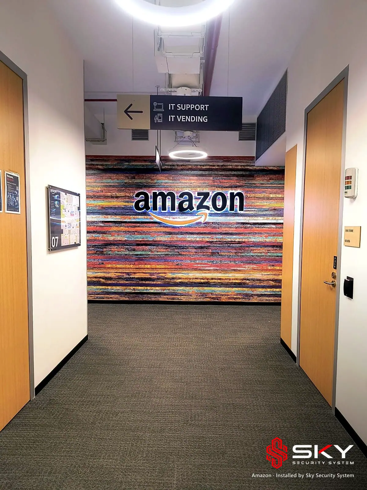 Office corridor with the Amazon brand wall at the Amazon site. Security and ELV work by Sky Security System.