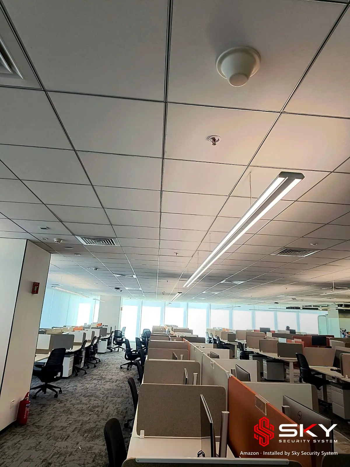 Open-plan office floor with ceiling devices at the Amazon site. Security and ELV work by Sky Security System.