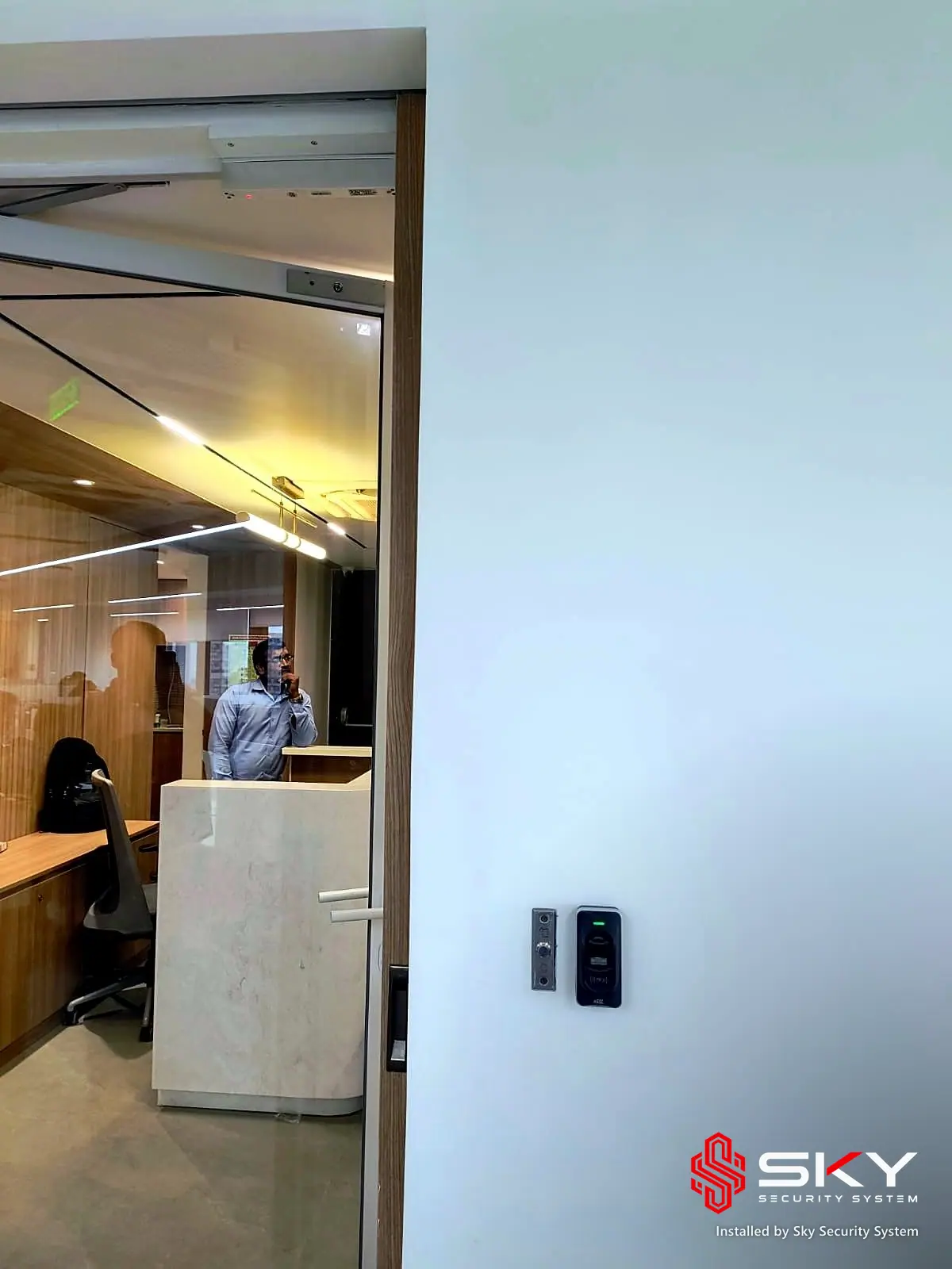 Access reader beside an office door at a corporate office, Andheri, Mumbai. Security and ELV work by Sky Security System.