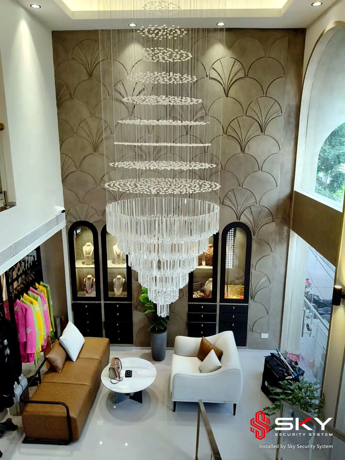 Double-height chandelier area at a fashion boutique, Hyderabad. Security and ELV work by Sky Security System.
