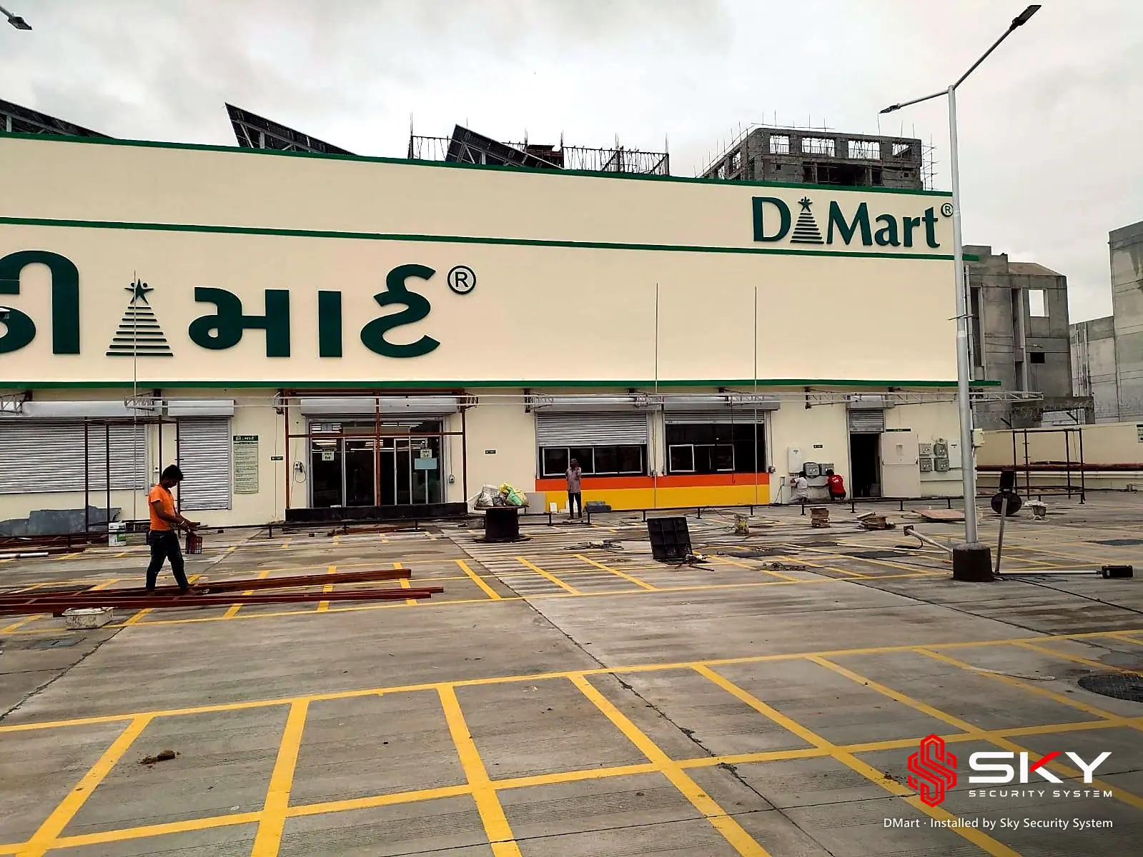 DMart store front and parking at the DMart site. Security and ELV work by Sky Security System.