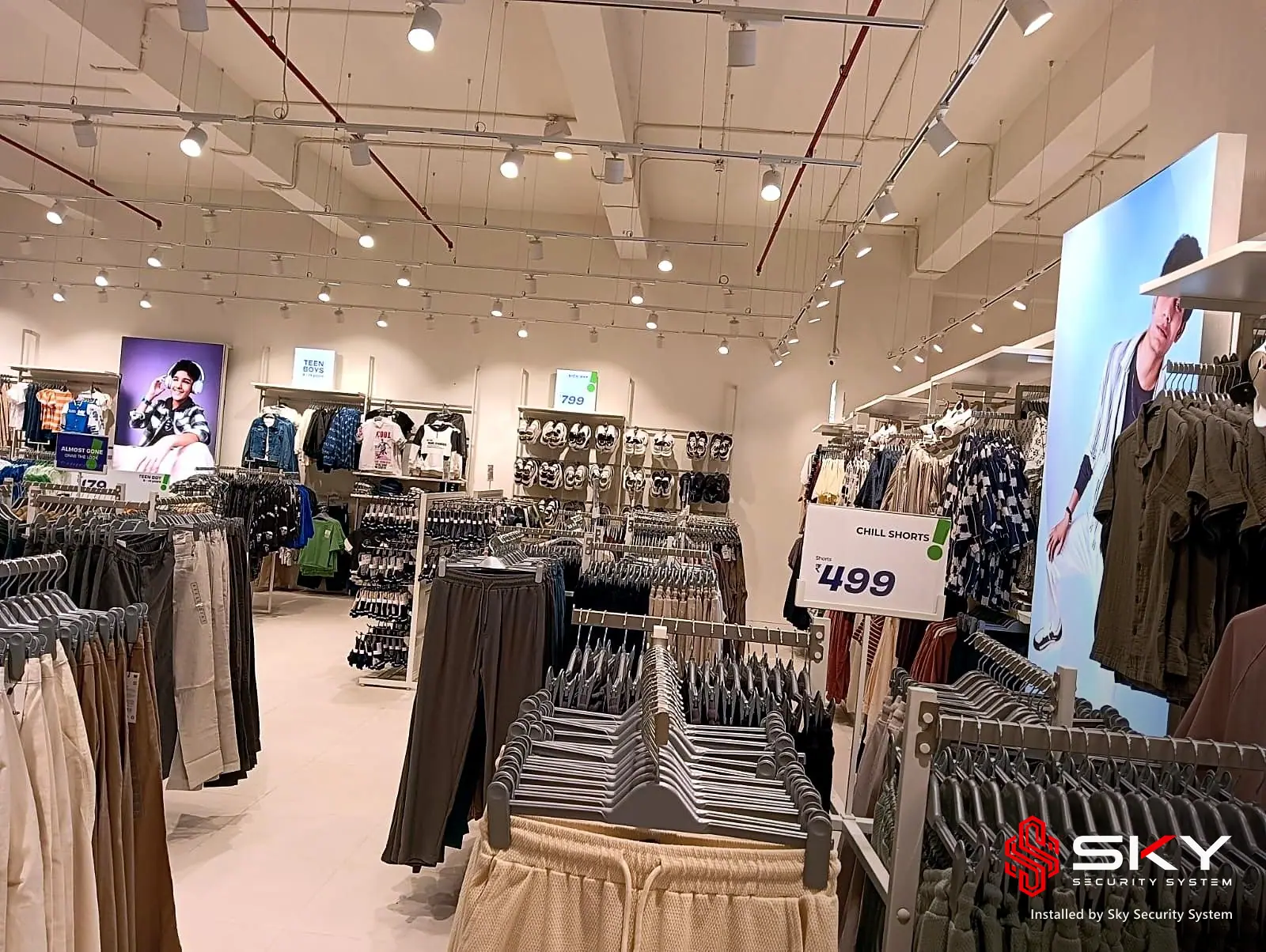 Clothing racks on the store floor at a fashion retail. Security and ELV work by Sky Security System.