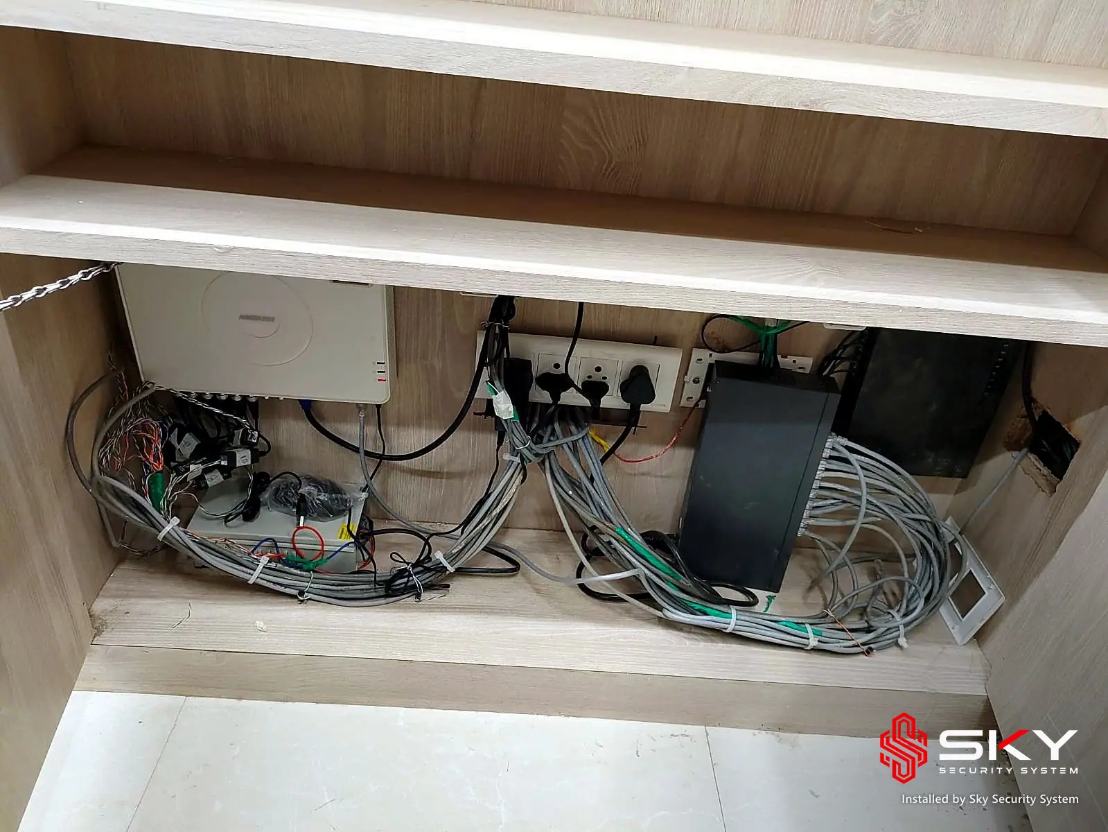 Network devices in a cabinet at a corporate office. Security and ELV work by Sky Security System.