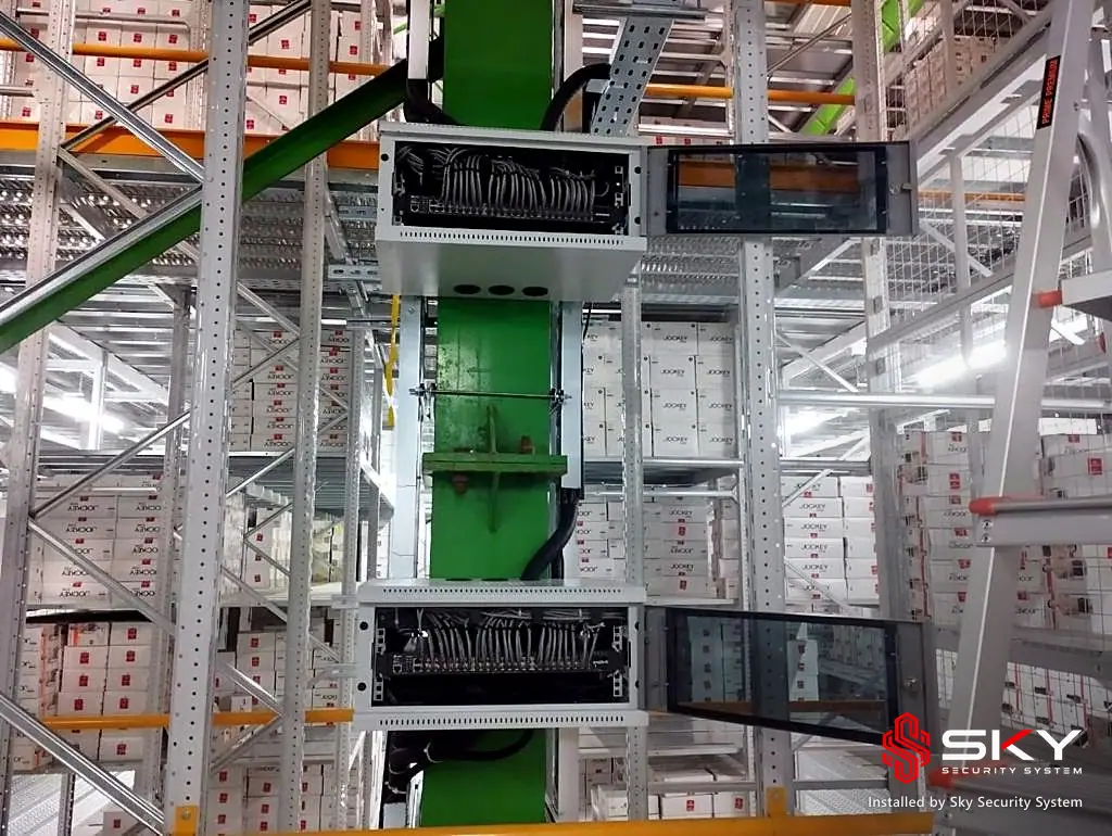 Network enclosures mounted on warehouse racking at an it office and warehouse. Security and ELV work by Sky Security System.