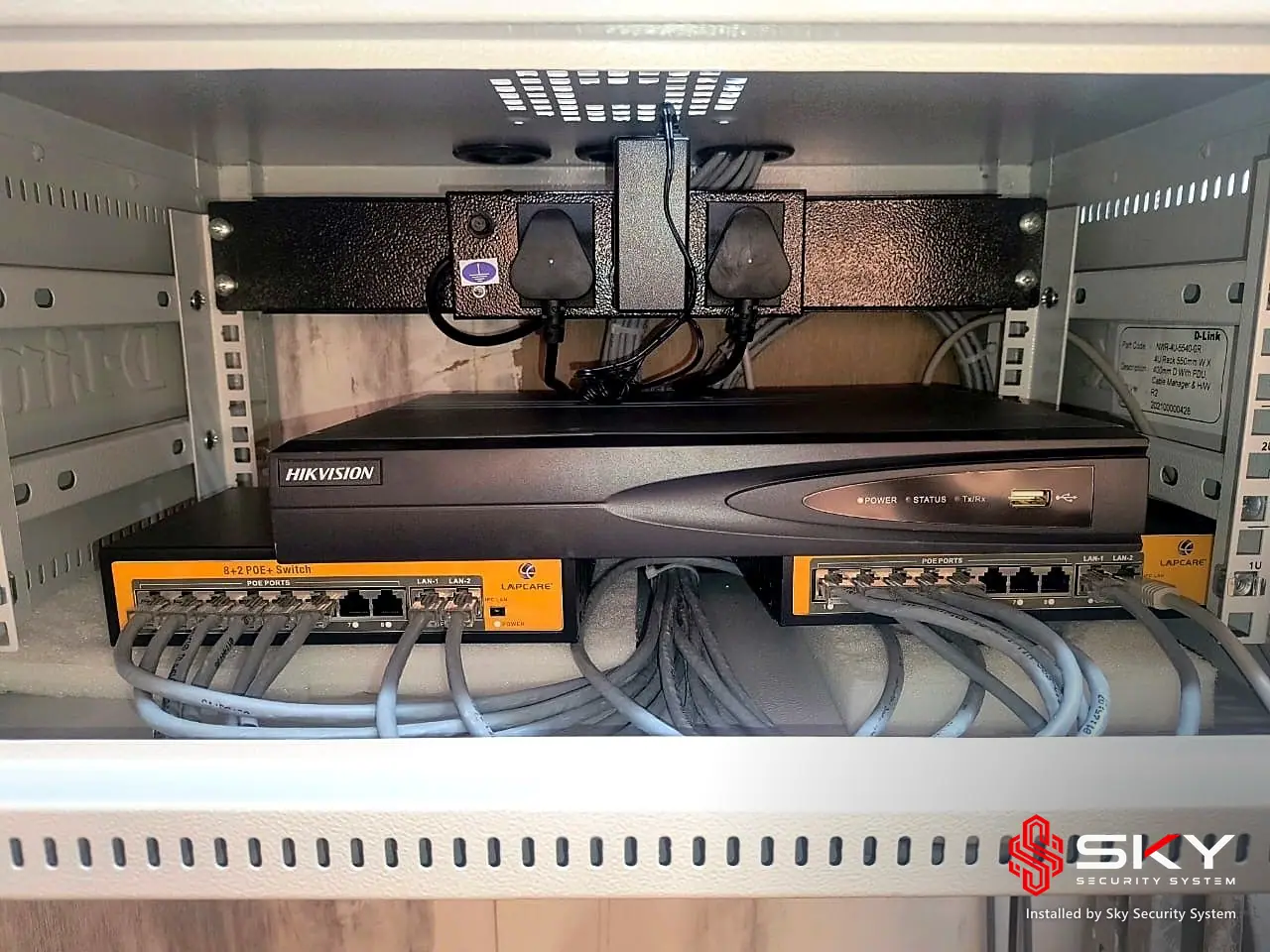 Recorder and PoE switches in a cabinet at an it office and warehouse. Security and ELV work by Sky Security System.