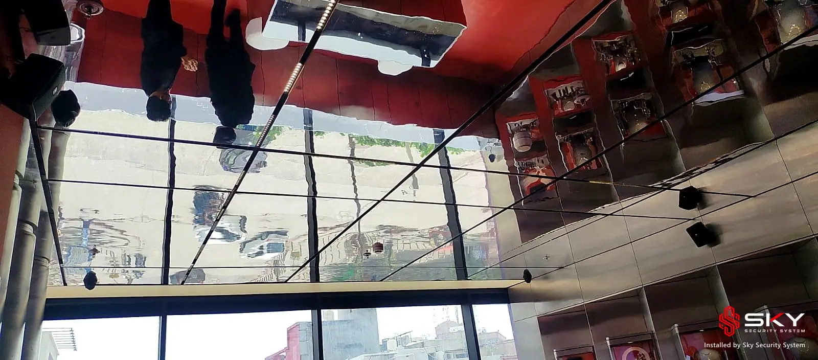 Mirrored ceiling and displays at a luxury retail. Security and ELV work by Sky Security System.