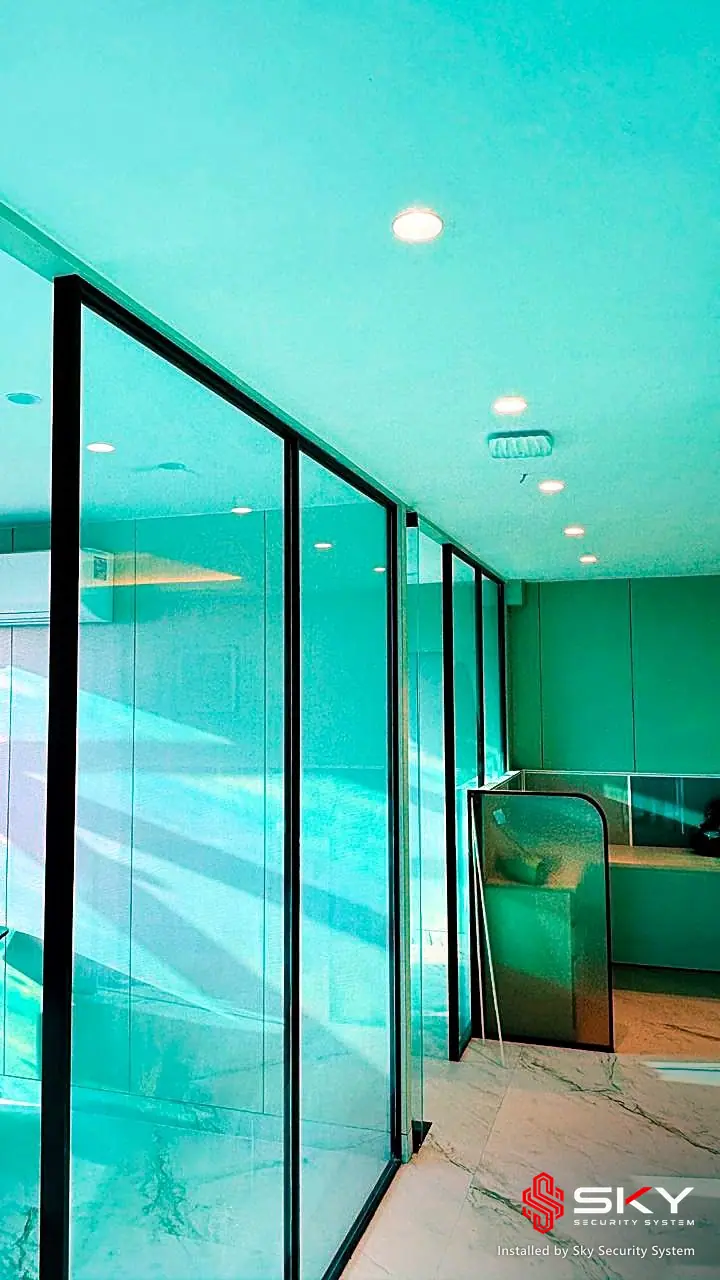 Glass partition corridor at a corporate office. Security and ELV work by Sky Security System.