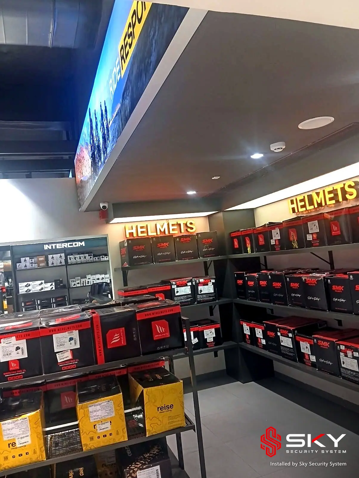 Helmet display wall at an automotive retail. Security and ELV work by Sky Security System.