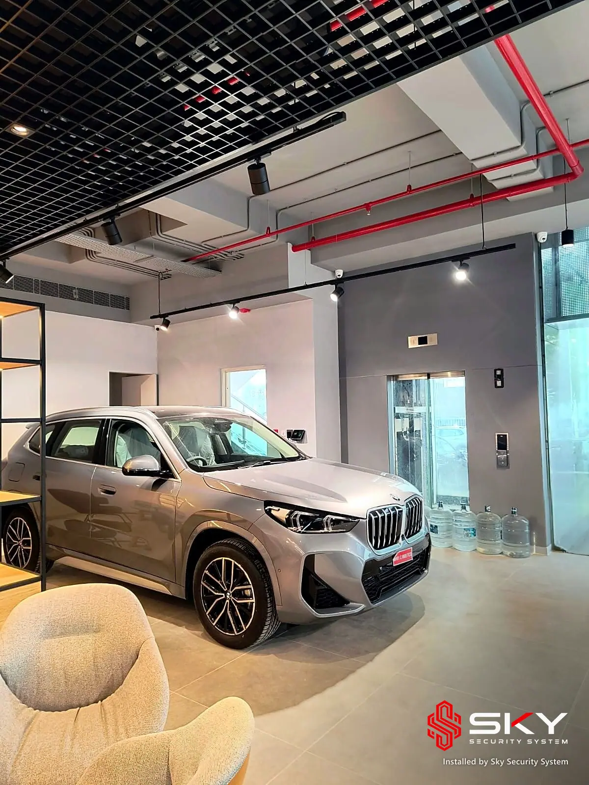Showroom floor with a display car at an automotive showroom. Security and ELV work by Sky Security System.